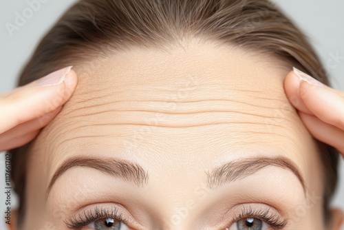 Close up of a woman s forehead showing wrinkles highlighting the effects of aging on facial skin