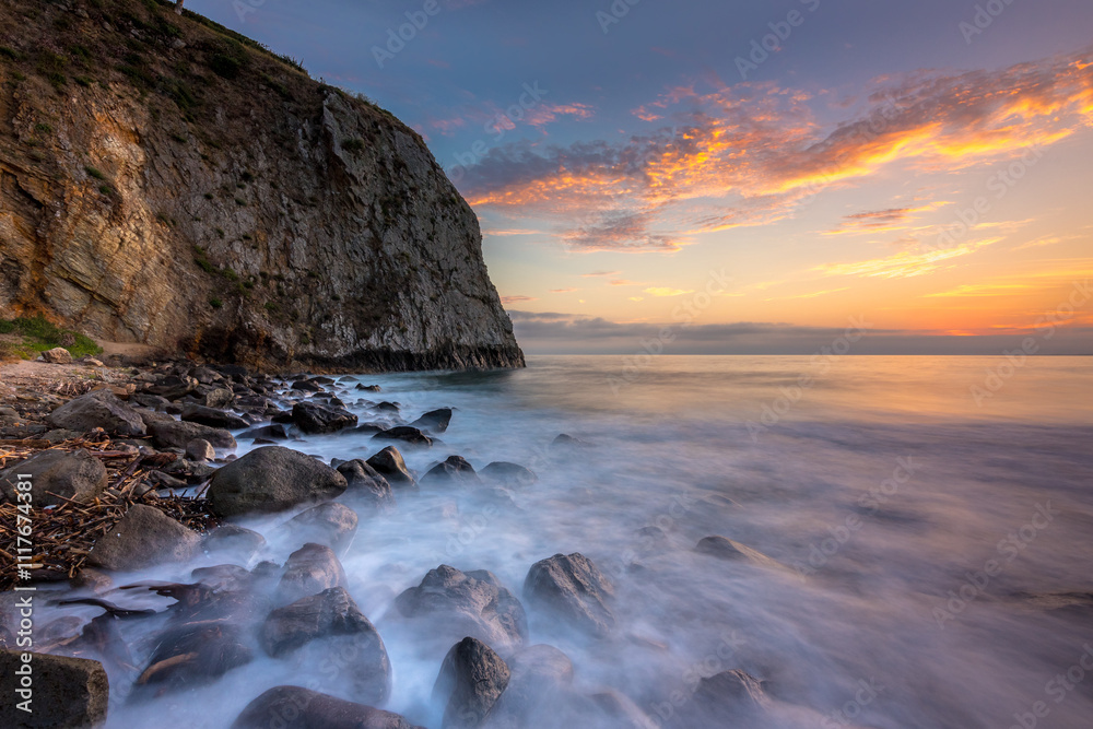 Sunset over rocky shore at Crystal Cove Beach