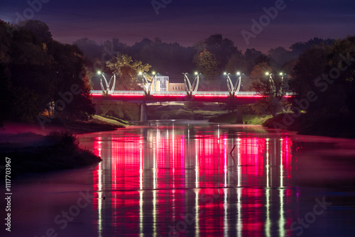 The bridge over the river Gauja is illuminated with lights. Valmiera