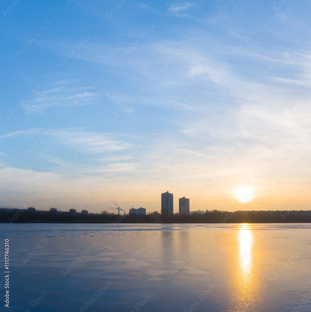 winter frozen river covered by snow with forest on coast at the sunset winter frozen river covered by snow with forest on coast at the sunset