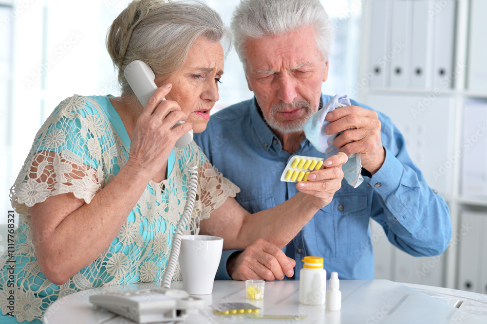 An elderly couple is sick and takes medication at home An elderly couple is sick and takes medication at home