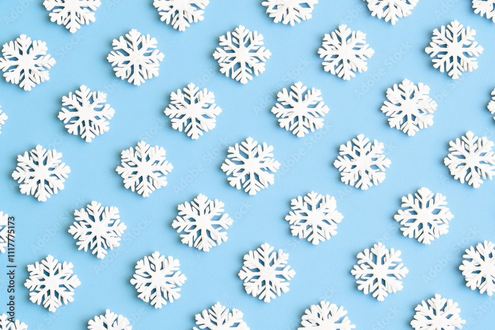 A close-up shot of many small snowflakes falling onto a blue surface A close-up shot of many small snowflakes falling onto a blue surface
