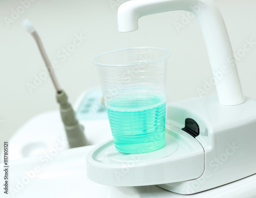 Dentist chair providing mouthwash for patient hygiene