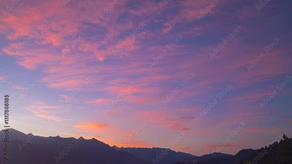 Purple and pink vivid clouds in sky. Romantic colorful sunrise above mountain tops. Concept of beauty world, travel outdoor, natural colorful shots Purple and pink vivid clouds in sky. Romantic colorful sunrise above mountain tops. Concept of beauty world, travel outdoor, natural colorful shots