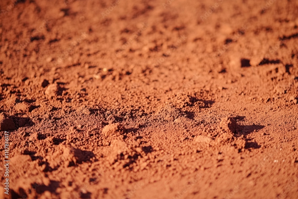 A close-up view of a dirt surface with small rocks, perfect for outdoor or nature-themed designs
