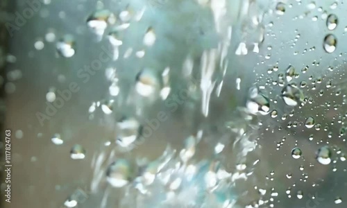 Dynamic macro shot capturing the motion of water droplets with blurred background, creating a sense of speed, fluid movement in a serene atmosphere.