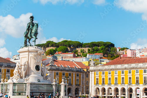 Vibrant View of Lisbon's Historic Praça do Comércio with Monumental Statue and Colorful Architecture Under a Clear Blue Sky