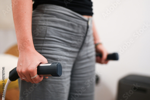 Patient using bioimpedance device for body composition analysis in nutrition clinic photo