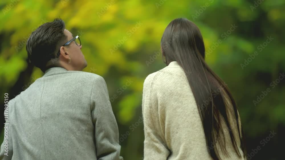 A lovely couple cherishes a peaceful moment in a vibrant autumn setting, fully embracing natures enchanting beauty A lovely couple cherishes a peaceful moment in a vibrant autumn setting, fully embracing natures enchanting beauty