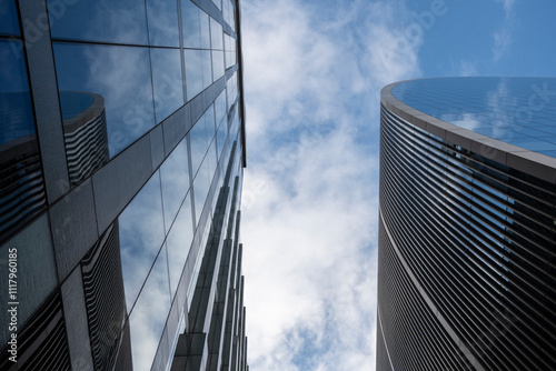 A captivating view of towering modern skyscrapers with glass facades reflecting the sky and clouds, showcasing the beauty of contemporary urban architecture and design in London UK photo