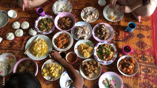 Chinese new year festival concept.Group of people in family eating lunch, with Food offerings on chinese new year festival, after pray of god, or ancestor worship