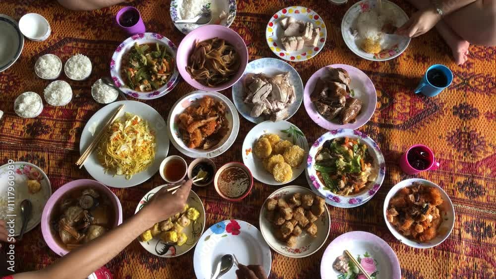 Chinese new year festival concept.Group of people in family eating lunch, with Food offerings on chinese new year festival, after pray of god, or ancestor worship Chinese new year festival concept.Group of people in family eating lunch, with Food offerings on chinese new year festival, after pray of god, or ancestor worship