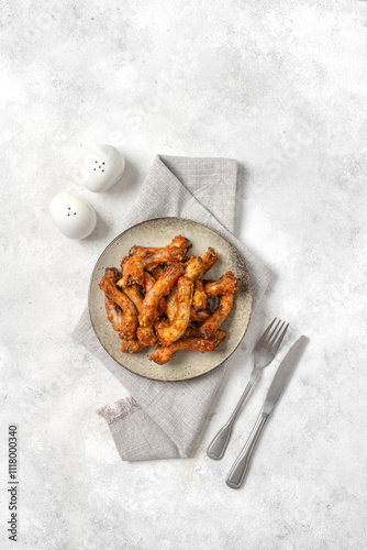 Obraz na płótnie Baked chicken necks in a ceramic plate on a light culinary background top view w salonie