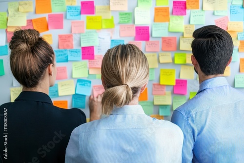 Team Members Collaborating in a Modern Office Environment with Sticky Notes on Wall