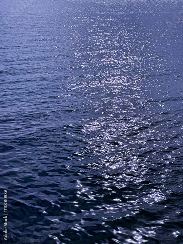 Blue ocean water glittering rippled surface. 