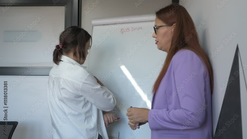 Schoolgirl and teacher have a lesson in the office, private lessons, distance learning Schoolgirl and teacher have a lesson in the office, private lessons, distance learning