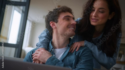 Caucasian man male husband boyfriend working online play video game internet addicted smiling love woman female girl girlfriend wife come in room at home surprise hugging guy finish work close laptop