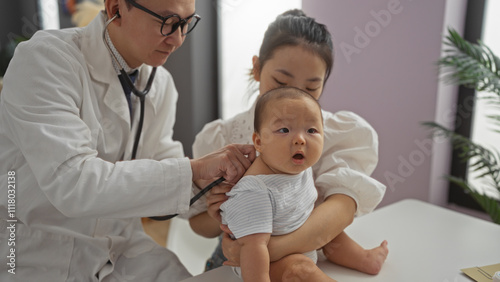 Doctor examines baby boy held by mother in hospital clinic room, showcasing family care and pediatric medical attention with chinese family indoors.