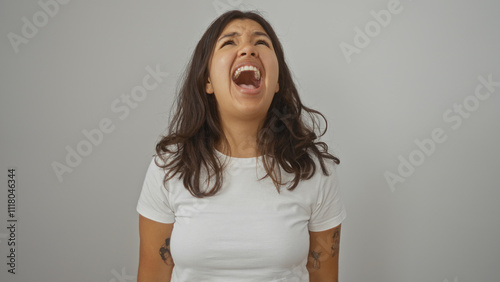 Slika na platnu Young woman screaming looking upwards with a frustrated expression in an isolate