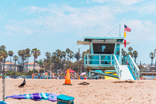 Wallpaper Mural Sunny California Beach Scene with Lifeguard Tower Amidst Palm Trees Capturing the Essence of Summer Relaxation and Coastal Adventure Under Vibrant Blue Skies and a Breezy Ocean Atmosphere Torontodigital.ca
