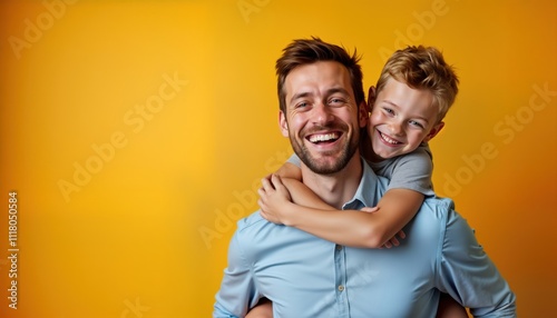 Happy father, son in studio photo. Father carrying son on back, both smiling. Background bright orange. Great photo for Father Day cards posters. Represents family love, joy. Great for family-related