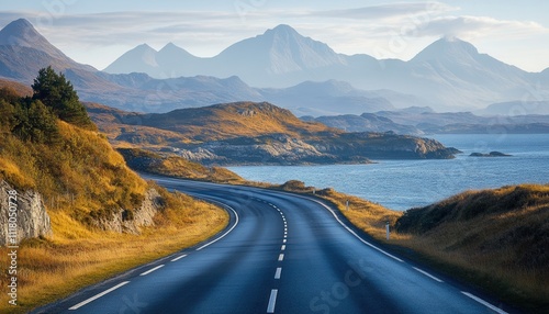 A scenic coastal road with mountains in the background.