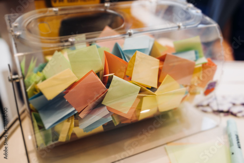 Process of prize drawings, extracting a winning numbers of lottery machine, raffle drum with a bingo balls, bingo machine and winning tickets on event with a female host, hands on lottery machine photo