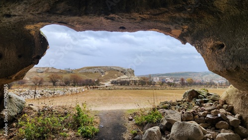 View of Uclerkayasi from the door of the Rock-cut Mythological Dungeon (Mitolojik Zindan) in Uclerkayasi village in Ihsaniye district in Afyonkarahisar province in the western Anatolia in Turkey. photo