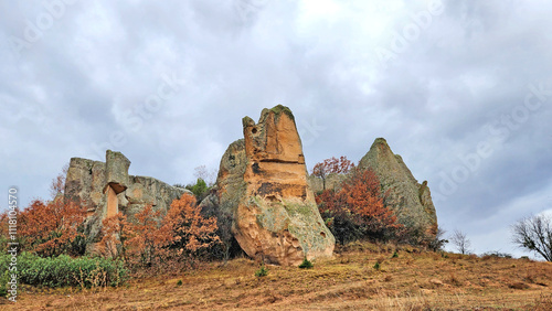 Beautiful rock formations in the west of famous Aslankaya Phyrgian Monument by the side of road to Doger town in Afyonkarahisar province in the evening of a severe rainy autumn day. photo