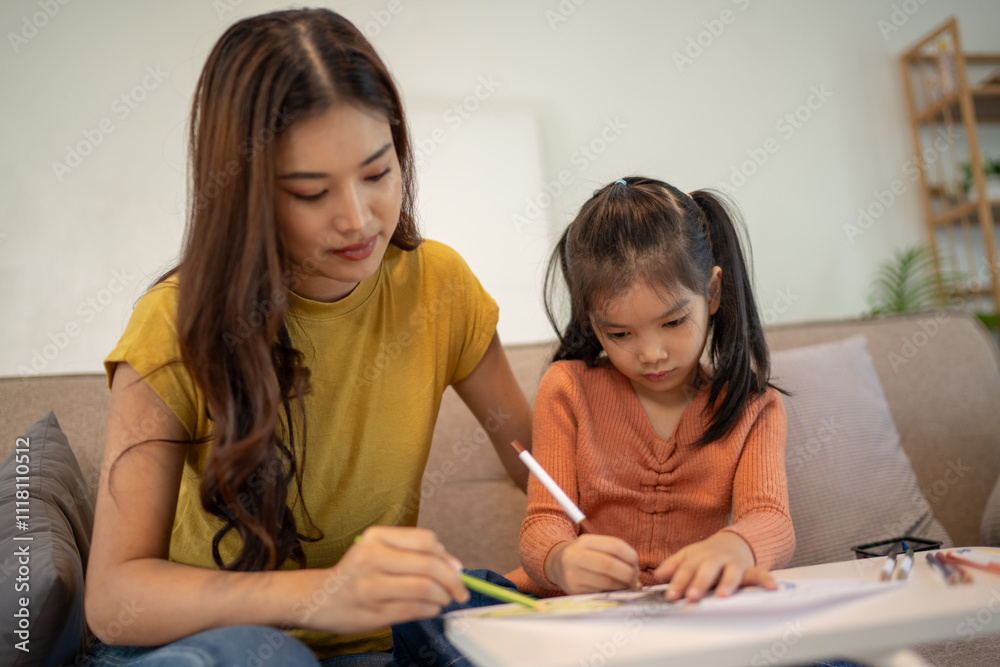 Lovely mom and little young daughter spending time together in their living room.