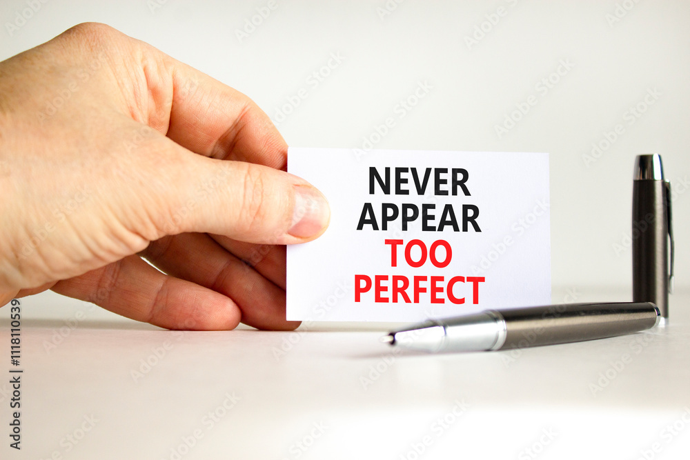 Never appear too perfect symbol. Concept words Never appear too perfect on beautiful white paper. Beautiful white background. Businessman hand. Business never appear too perfect concept. Copy space. Never appear too perfect symbol. Concept words Never appear too perfect on beautiful white paper. Beautiful white background. Businessman hand. Business never appear too perfect concept. Copy space.