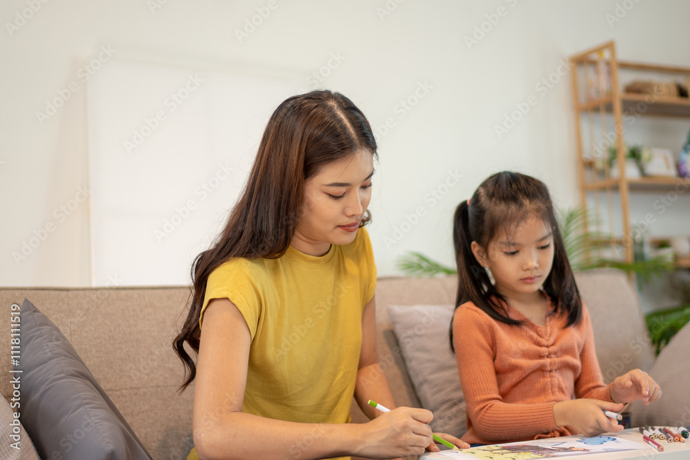 Lovely mom and little young daughter spending time together in their living room. Lovely mom and little young daughter spending time together in their living room.