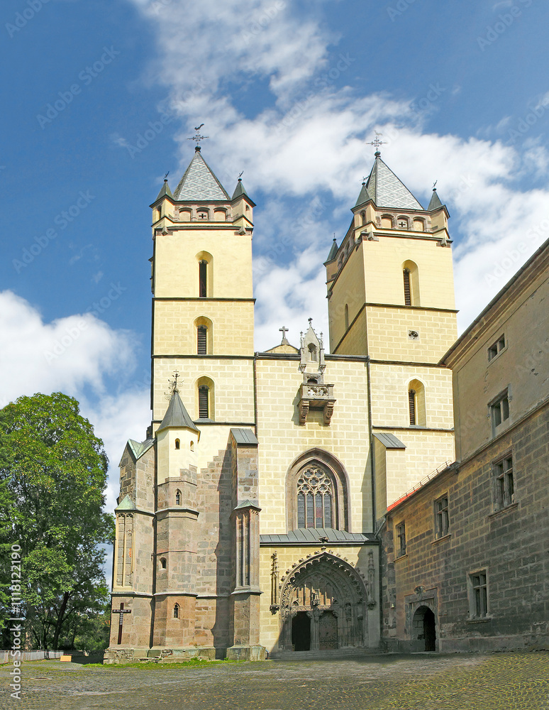 Fototapeta premium The monastery complex of Hronsky Benadik consists of a 14 th century Gothic basilica, monastery buildings, courty-yards and a fortifications. Is situated in the valley of the Hron river. Slovakia