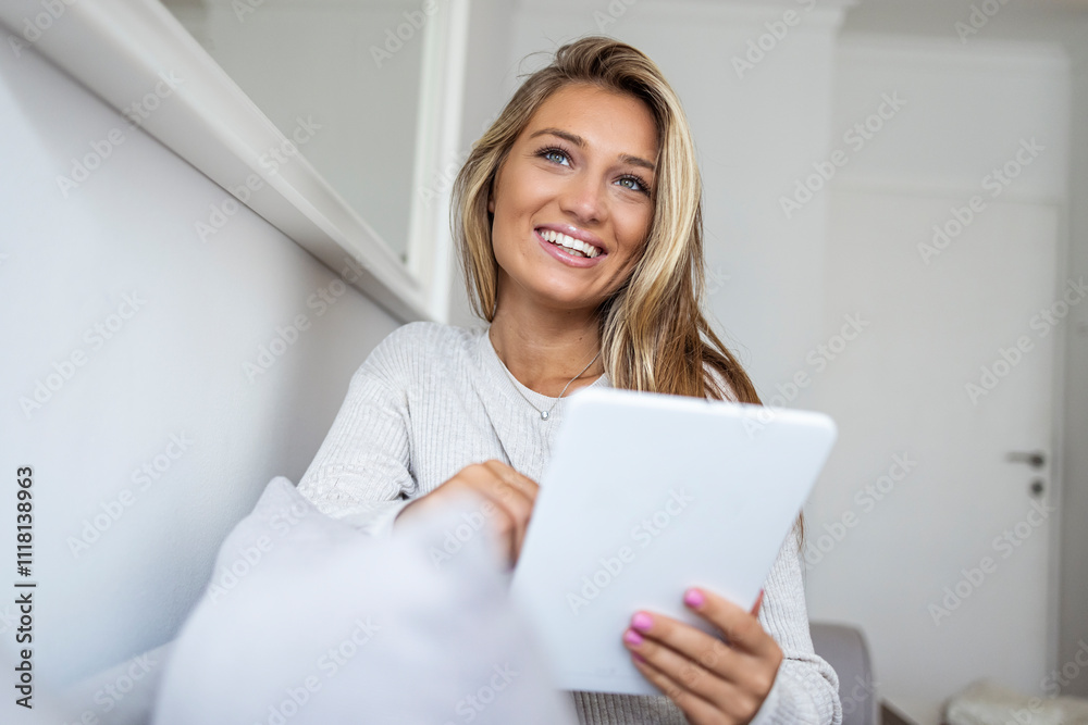Smiling Woman Relaxing at Home with a Tablet Device Smiling Woman Relaxing at Home with a Tablet Device