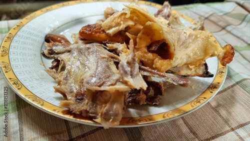 A plate of leftover chicken bones and skin