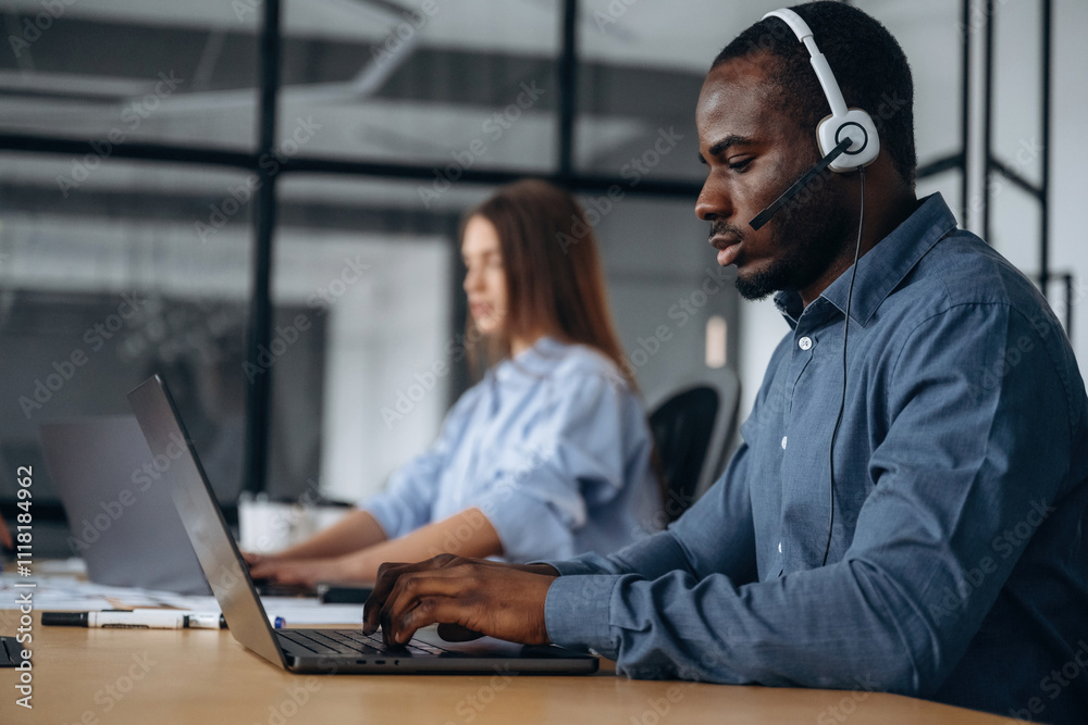 In headphones and with laptops. People are working in the call center