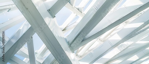 Intricate white structural beams crisscross against a clear sky, forming a geometric abstraction of light and shadow. photo