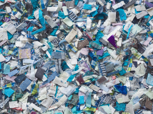 Recycling of old clothes. Zero waste concept. Textile recovery. Reusable of clothes. Second life project. Recycling, reuse, circular, up cycling, reprocessing. Blue pieces of old fabric repurposing.