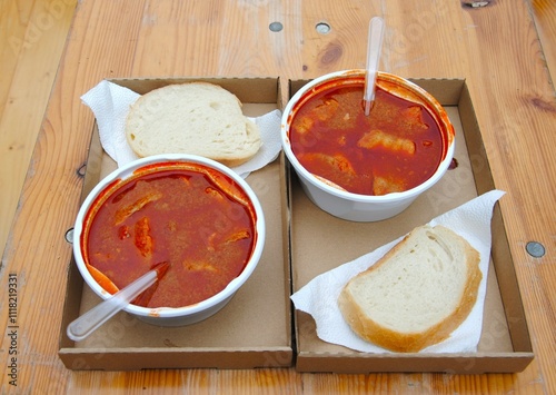 catfish soup made in a cauldron at a gastronomic festival in Budapest, served on a plastic plate. photo