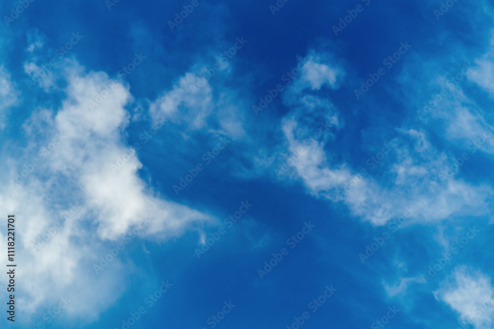 Fototapeta premium Blue sky with moving blurred white clouds, soft focus, blurred contours, dynamics of movement of air masses and aerosols in the air, haze