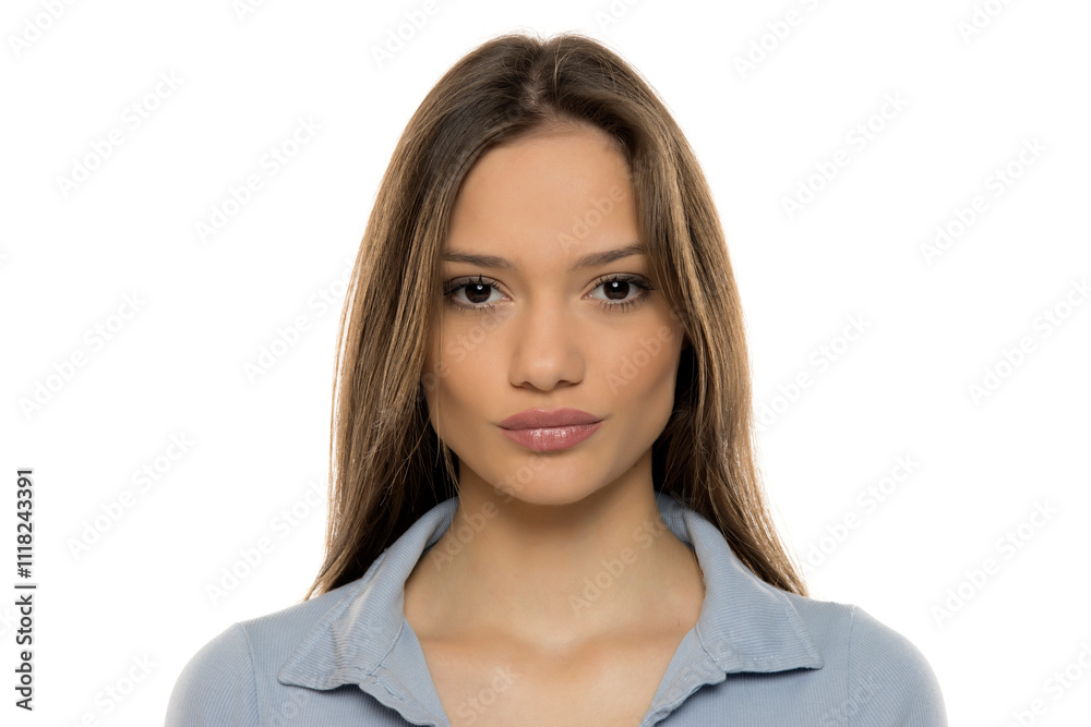 Portrait of a beautiful young serious woman with makeup on a white studio background Portrait of a beautiful young serious woman with makeup on a white studio background