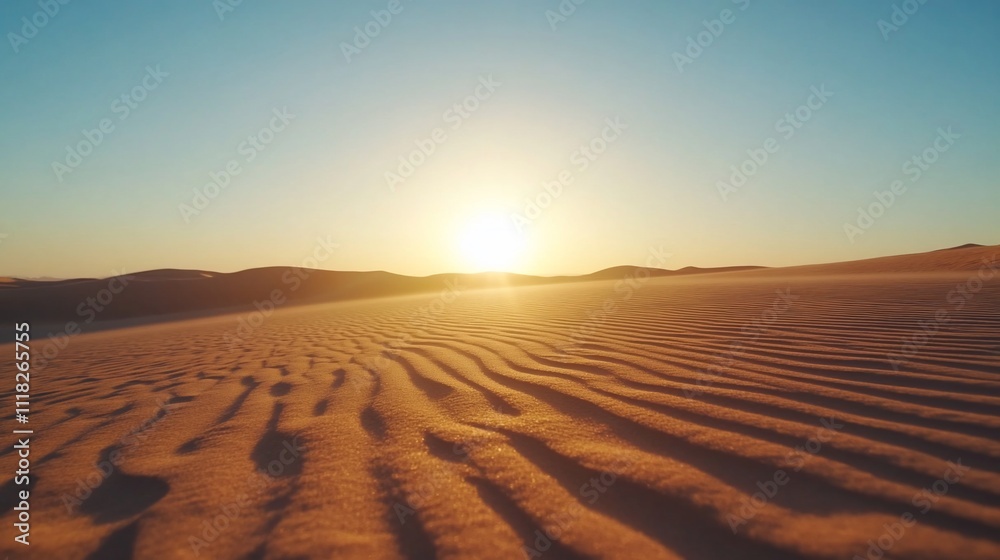 Naklejka premium Serene desert landscape at sunset with gentle sand dunes.