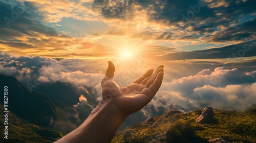 Hand Reaching Towards Sunset Over Mountains