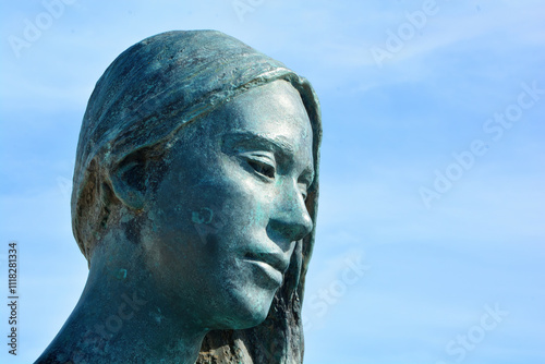 statue on the harbour wall Latchi, Cyprus. Regina