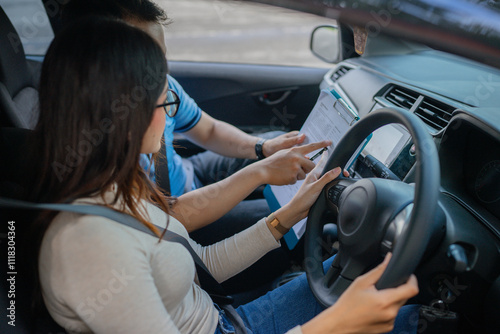 A student driver is getting crucial instructions incar for a safe driving experience photo