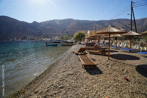 Fototapeta Naklejka Na Ścianę i Meble -  sunbeds and sunshades on the beach of Pedi , Greece
