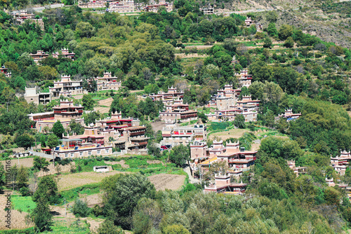 Sichuan, China-Oct 18 2024: Jiaju Tibetan Village, Danba, concentrated place for Jiarong Tibetans with hundreds of Tibetan-style houses built along the mountains fertile fields, picturesque landscapes photo