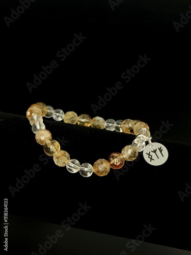 bracelet made of expensive natural stone with silver inserts and a pendant with runes