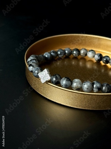 bracelet made of expensive natural stone with silver inserts and a pendant with runes