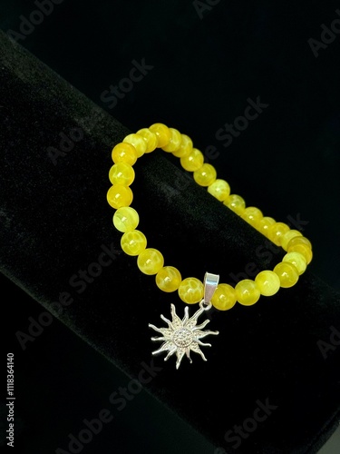 bracelet made of expensive natural stone with silver inserts and a pendant with runes